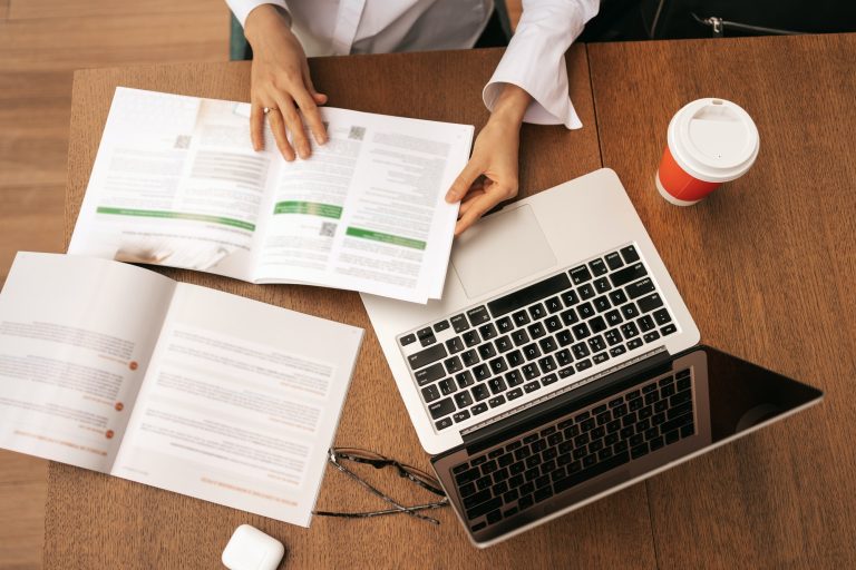 Close up businesswoman hands working while sitting at table