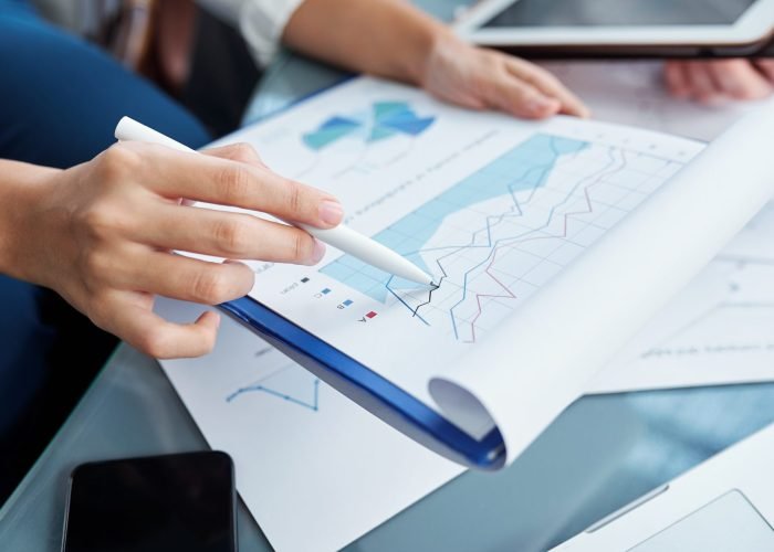 Analyzing sales and expenses Close-up image of businesswoman pointing at financial chart and analyzing sales and expenses