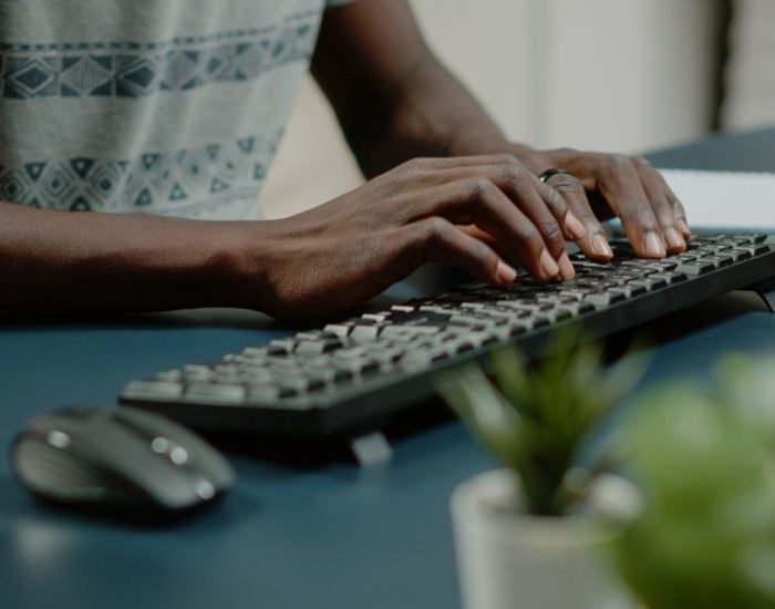 Close up of hands using computer keyboard and listening to music Close up of hands using computer keyboard and listening to music